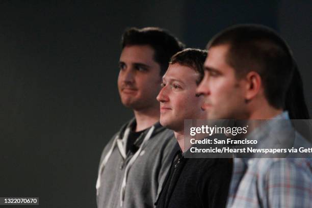 Mark Zuckerberg stands with Chris Struhar , tech lead and Julie Zhuo , director of design and Chris Cox , vice president of product during a press...