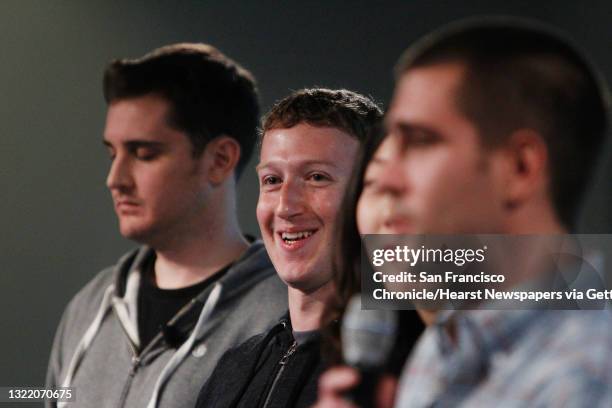 Mark Zuckerberg stands with Chris Struhar , tech lead and Julie Zhuo , director of design as Chris Cox , vice president of product speaks during a...