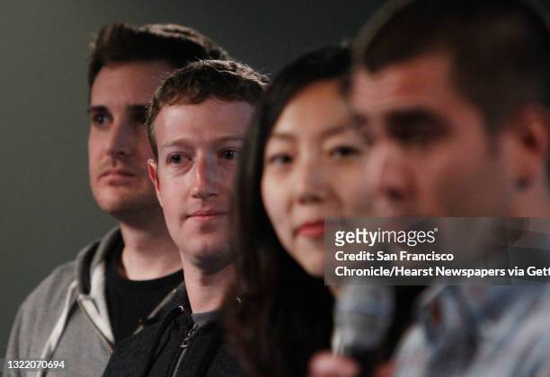 Mark Zuckerberg stands with Chris Struhar , tech lead and Julie Zhuo , director of design as Chris Cox , vice president of product speaks during a...