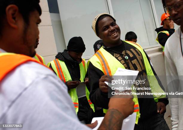 Jay Davis collects his first paycheck from team leader Robert Taito , 25 as he and others in the second 5 week-session of the San Francisco...