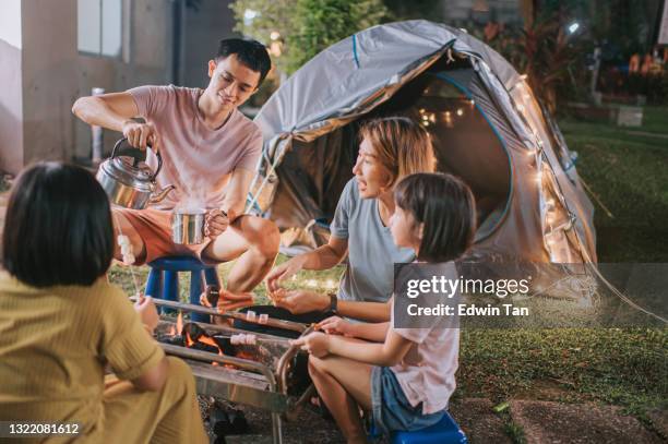 asian chinese family with 2 daughters enjoying bbq grill camping at backyard of their house staycation weekend activities - backyard stock pictures, royalty-free photos & images