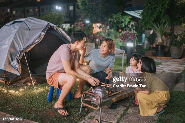 asian chinese family with 2 daughters enjoying bbq grill camping at backyard of their house staycation weekend activities - chinese eating backyard stock pictures, royalty-free photos & images