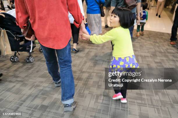 father and child holding hands walking in the crowded shopping mall - 父の日　日本 ストックフォトと画像