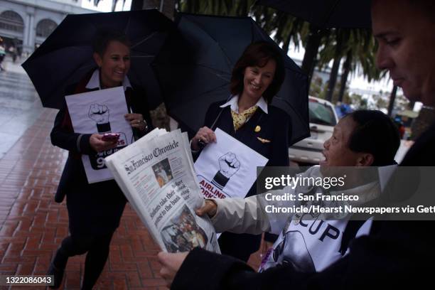 American Airline flight attendants Heidi Cain , Julie Hedrick and Larry Salas talk with Occupy San Francisco camper Christy Wong of San Jose as she...