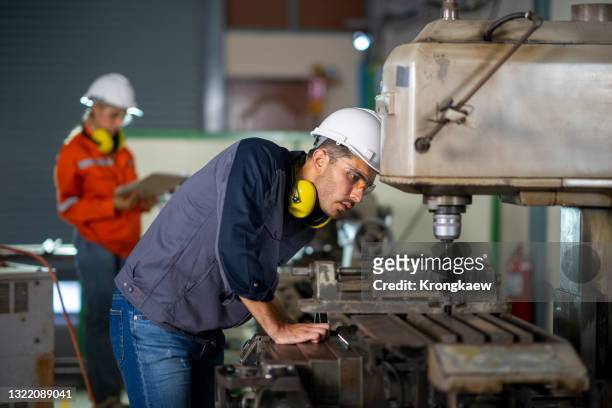 maintenance engineer testing roll bars and using grinder or drill. - milling stock pictures, royalty-free photos & images