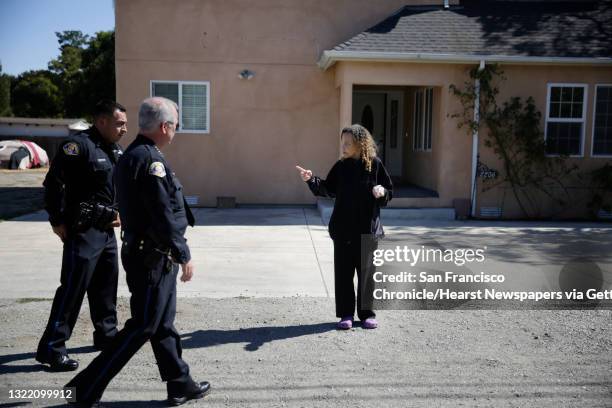 Eather Aleem of East Palo Alto stops to talk with East Palo Alto police chief Al Pardini and East Palo Alto police commander Jerry Alcaraz on Friday,...