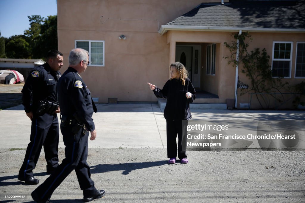 Eather Aleem of East Palo Alto stops to talk with East Palo Alto police chief Al Pardini (center) and East Palo Alto police commander Jerry Alcaraz (left) on Friday, October 2, 2015 in East Palo Alto, Calif.
