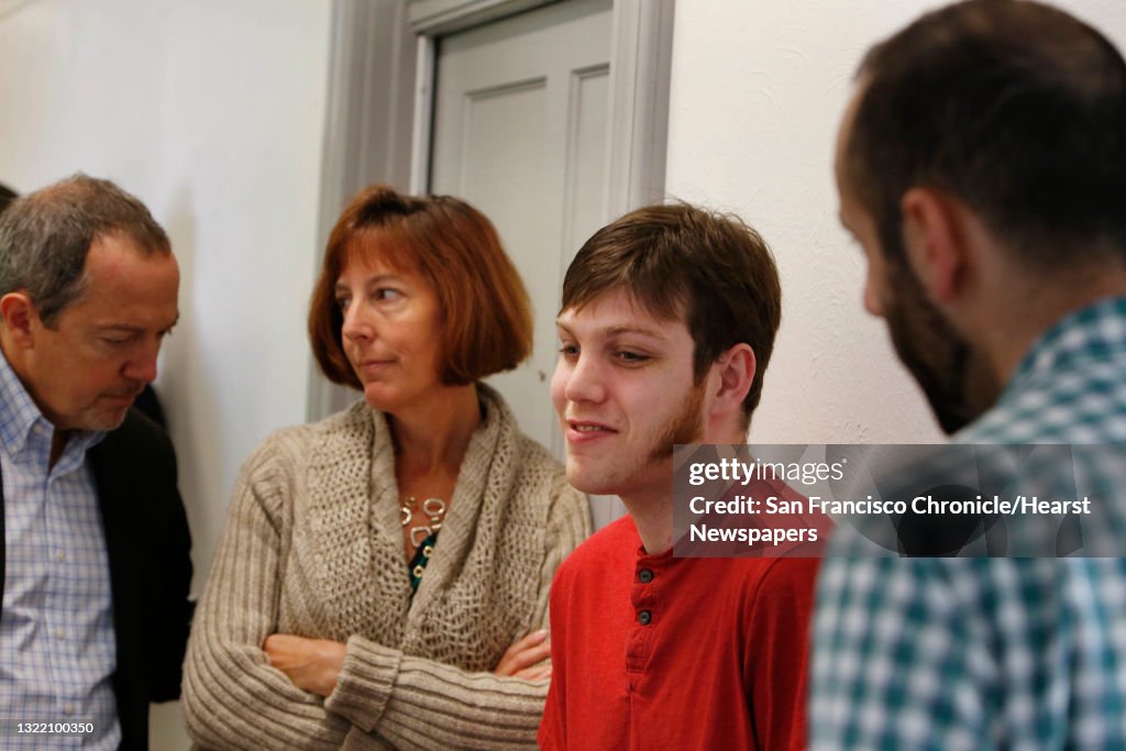 Michael S. (second from right) talks with Danny Yadegar (right), project manager Community Housing Partnership, on the third floor at the Edward II along with Sherilyn Adams (second from left), executive director Larkin Street Youth Services and Bevan Duf