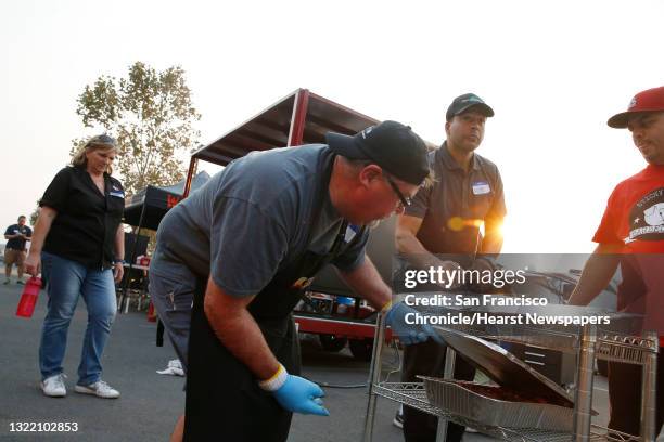 Kevin O'Grady competition barbeque cook with team "Royal Smoking Hot" coordinates a donation of barbeque with Victor Scargle of Napa and Tedd Romero...