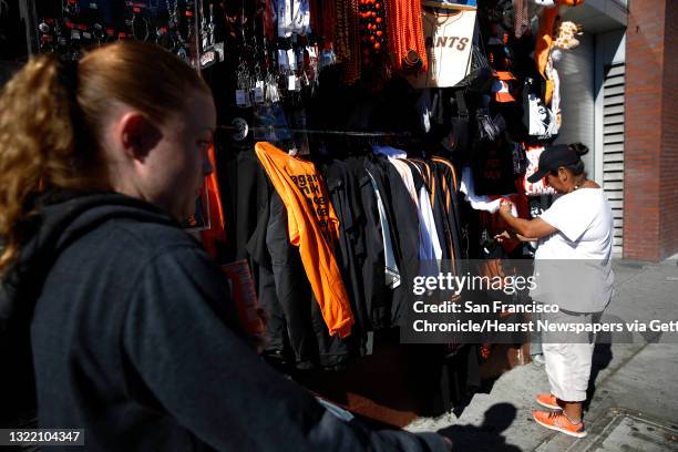 Violeta Cortegana arranges items in a booth across from AT&T Park as she prepares for Game 6 of the World Series on Tuesday, October 28, 2014 in San...