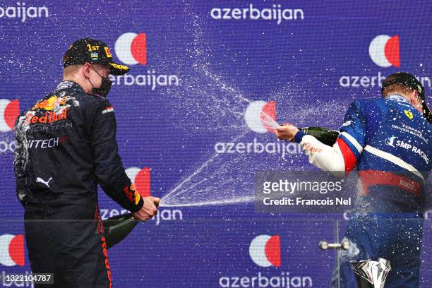 Race winner Juri Vips of Estonia and Hitech Grand Prix and third placed Robert Shwartzman of Russia and Prema Racing celebrate with sparkling wine on...