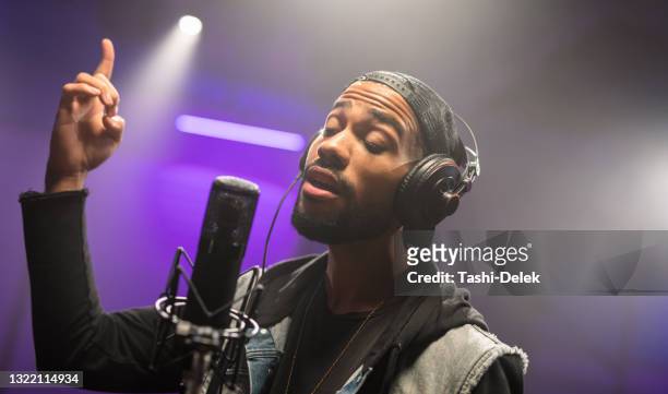 african american musician recording his singing in recording studio - rapper stock pictures, royalty-free photos & images