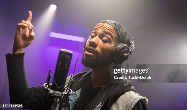 african american musician recording his singing in recording studio - låtskrivare bildbanksfoton och bilder