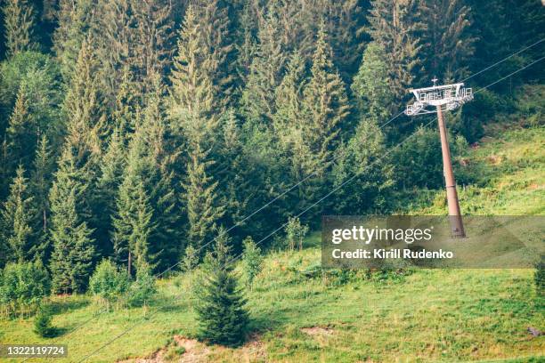 ski lift pole o na mountain slope in summer - ski lift summer stock pictures, royalty-free photos & images