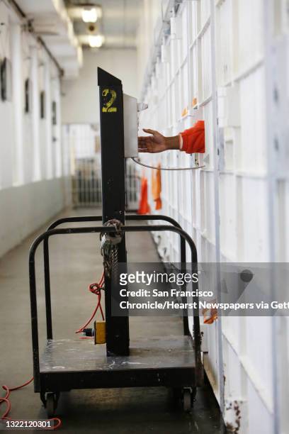 An inmate uses a rollaway phone at the jail at the Hall of Justice on Tuesday, December 1, 2015 in San Francisco, Calif.