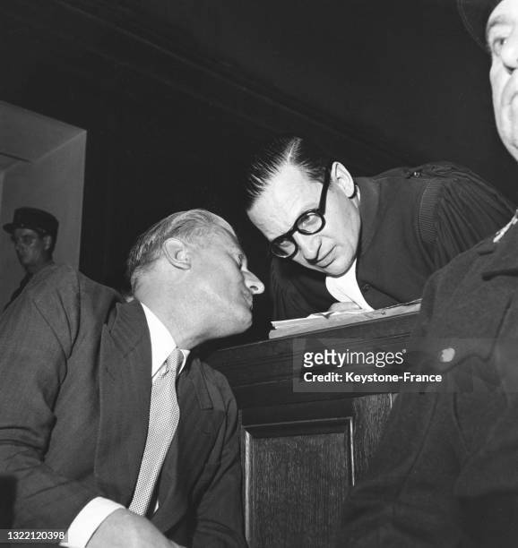 Otto Abetz discutant avec son avocat René Floriot lors de son procès, le 18 juillet 1949, à Paris.