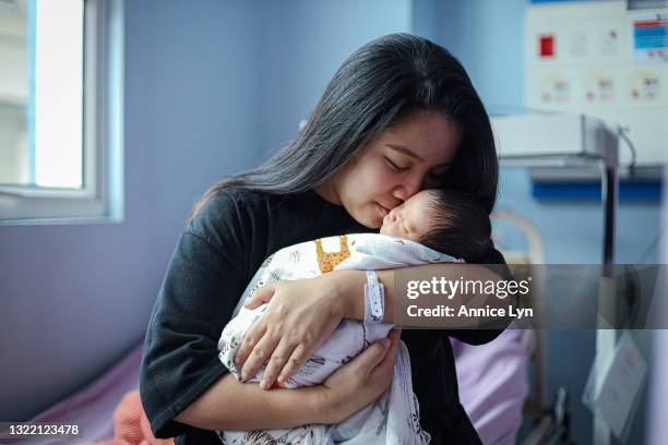 Gladys kisses her newborn, Ezra on his cheeks in a hospital on June 04, 2021 in Kuala Lumpur, Malaysia. The Covid-19 crisis has changed the way women...