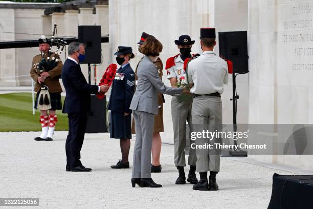 British ambassador, Lord Llewellyn and French defence minister Florence Parly lay wreaths of flowers during an official opening of the British...