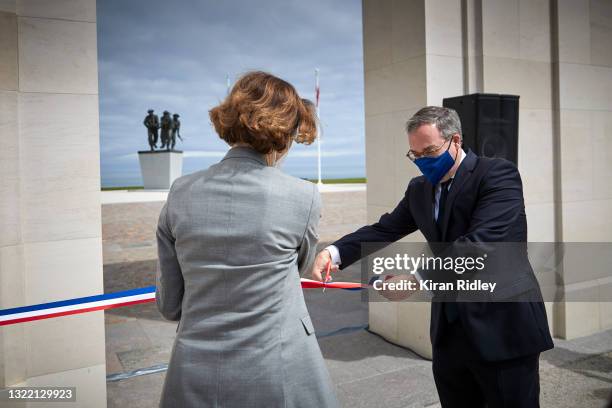 British Ambassador to France Lord Edward Llewellyn cuts the opening ribbon with French Defence Minister Florence Parly during the opening ceremony of...