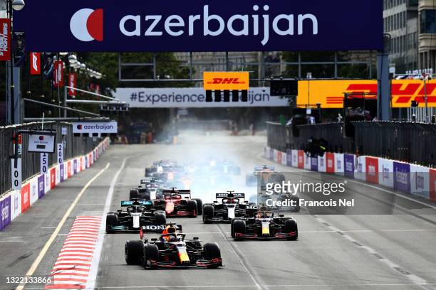 Max Verstappen of the Netherlands driving the Red Bull Racing RB16B Honda leads Sergio Perez of Mexico driving the Red Bull Racing RB16B Honda and...