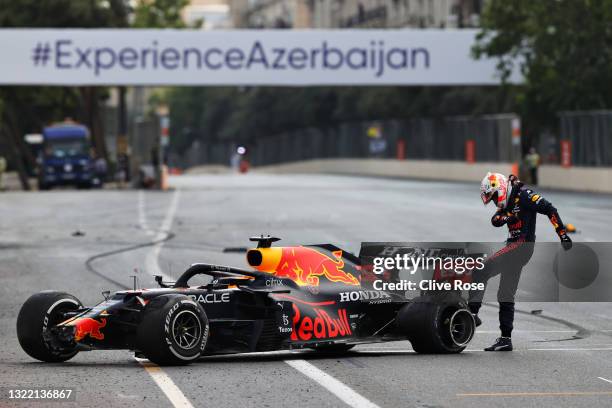 Max Verstappen of Netherlands and Red Bull Racing kicks his tyre as he reacts after crashing during the F1 Grand Prix of Azerbaijan at Baku City...