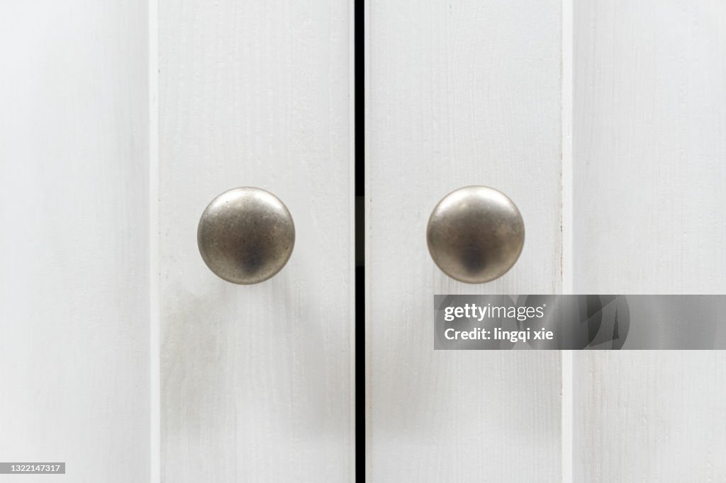 White cabinet with golden handles