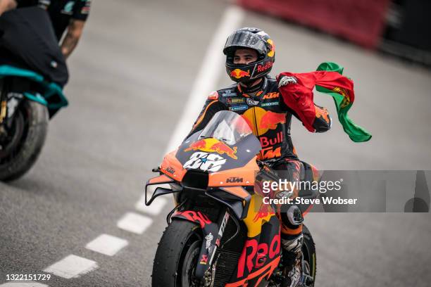 Miguel Oliveira of Portugal and Red Bull KTM Factory Racing with his Portuguese flag rolls into parc ferme after his race win during the MotoGP Gran...