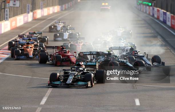 Lewis Hamilton of Great Britain driving the Mercedes AMG Petronas F1 Team Mercedes W12 runs wide after locking up at the restart following a red flag...