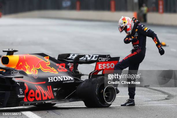 Max Verstappen of Netherlands and Red Bull Racing kicks his tyre as he reacts after crashing during the F1 Grand Prix of Azerbaijan at Baku City...