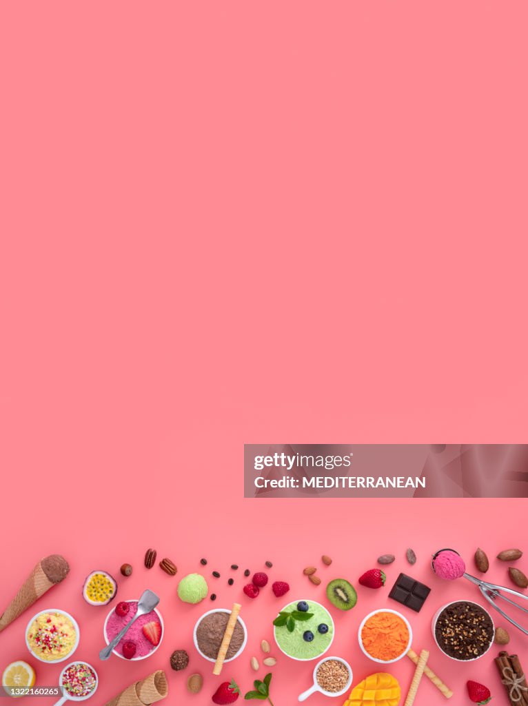 Assorted ice cream cups in a row and waffle cones colorful on pink background