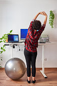 Woman telecommuting at an adjustable standing desk
