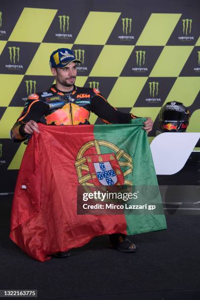 Miguel Oliveira of Portugal and Red Bull KTM Factory Racing shows the flag during the press conference at the end of the MotoGP race during the...