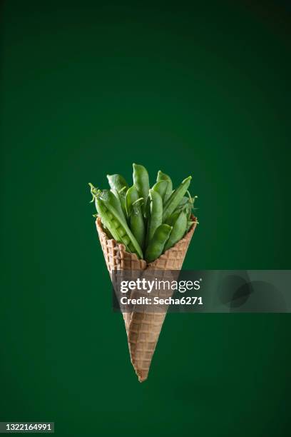 peas on a green background - springtime food stock pictures, royalty-free photos & images