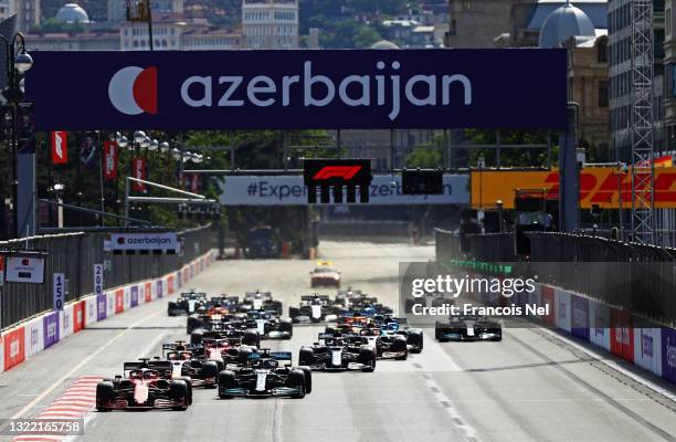 Charles Leclerc of Monaco driving the Scuderia Ferrari SF21 leads Lewis Hamilton of Great Britain driving the Mercedes AMG Petronas F1 Team Mercedes...