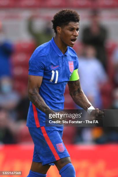 Marcus Rashford of England celebrates after scoring their side's first goal from the penalty spot during the international friendly match between...