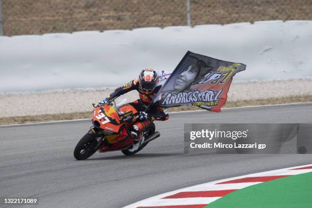 Pedro Acosta of Spain and Red Bull KTM Ajo remembers Andreas Perez of Spain with the flag during the Moto3 race during the MotoGP of Catalunya - Race...