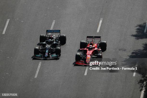 Lewis Hamilton of Great Britain driving the Mercedes AMG Petronas F1 Team Mercedes W12 and Charles Leclerc of Monaco driving the Scuderia Ferrari...