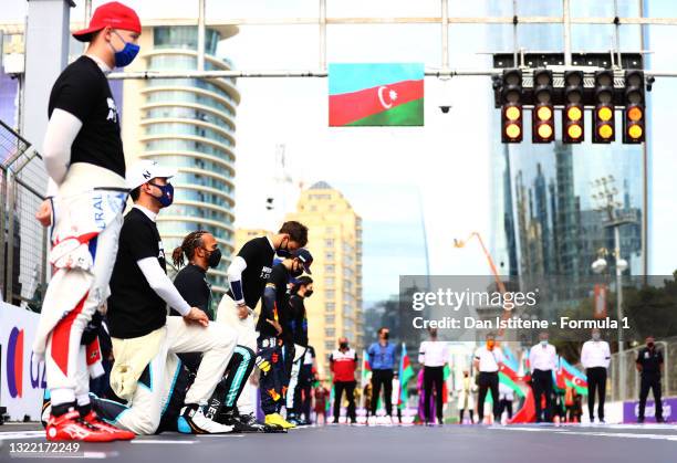 Nicholas Latifi of Canada and Williams and Lewis Hamilton of Great Britain and Mercedes GP take a knee on the grid in support of the Black Lives...