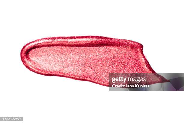 red glitter lipstick mark on white background isolated. lip gloss, nail polish smear. products for makeup and skin care. beauty cosmetics. cosmetology. closeup. - lip gloss smudge stock-fotos und bilder