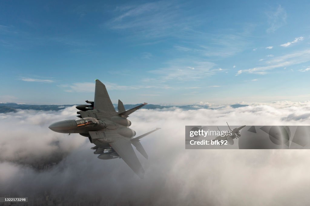 Jet fighters flying over the clouds.