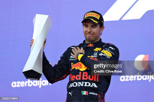 Race winner Sergio Perez of Mexico and Red Bull Racing celebrates on the podium during the F1 Grand Prix of Azerbaijan at Baku City Circuit on June...