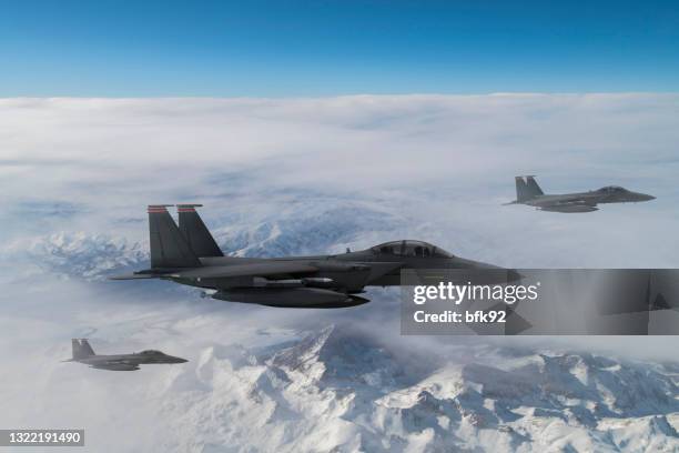 jet fighters flying over the clouds. - defense industry stock pictures, royalty-free photos & images