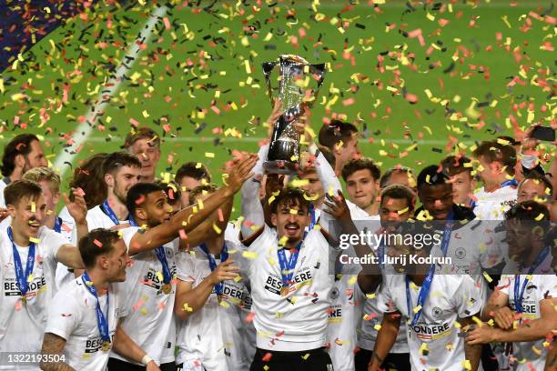 Mergim Berisha of Germany lifts the UEFA European Under-21 Championship trophy in celebration with team mates after winning the 2021 UEFA European...
