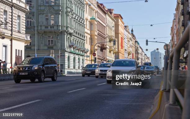 daytime traffic in a one-way street downtown prague - vw bus stock pictures, royalty-free photos & images