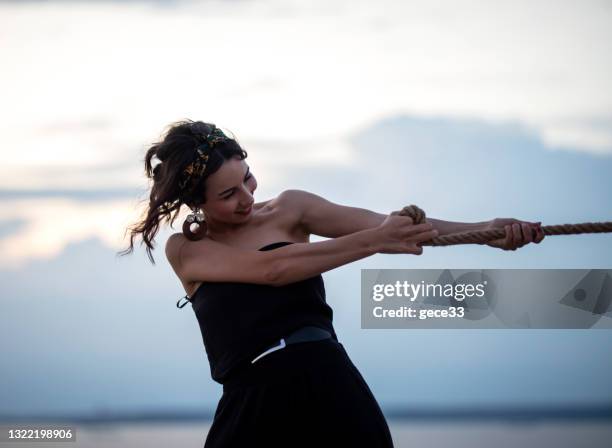Woman Pulling Rope Photos and Premium High Res Pictures - Getty Images