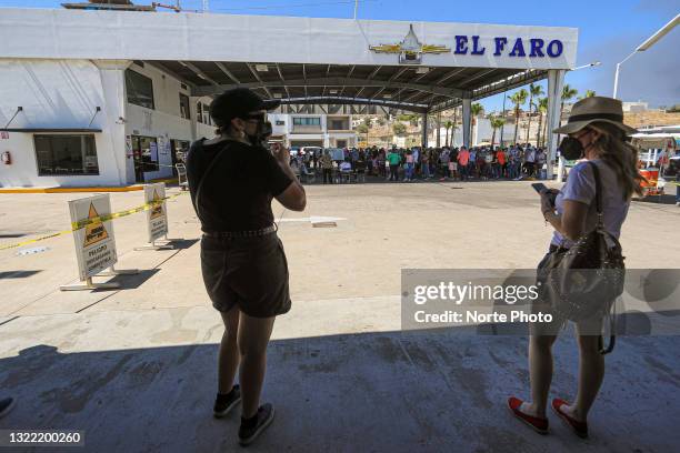 Citizens take refuge from the sun under a shade as waiting to cast their vote in the special box known as El Faro on June 6, 2021 in Hermosillo,...