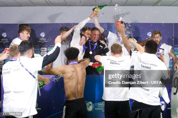 Stefan Kuntz, Head Coach of Germany celebrate with his players during a press conference after winning the 2021 UEFA European Under-21 Championship...