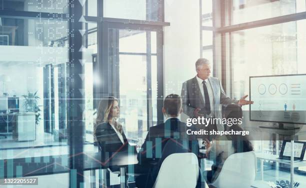 digitally enhanced shot of a group of businesspeople meeting in the boardroom superimposed over a graph showing the ups and downs of the stock market - economy business and finance imagens e fotografias de stock