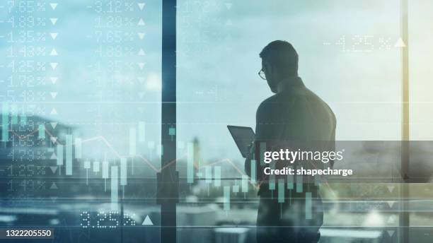 digital verbesserte aufnahme eines nicht erkennbaren geschäftsmannes mit einem tablet, das über einem diagramm überlagert wird, das die auf und ab des aktienmarktes zeigt - börsenhandel finanzberuf stock-fotos und bilder
