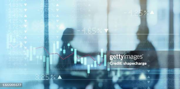 digitally enhanced shot of a two businesspeople shaking hands in the boardroom superimposed over a graph showing the ups and downs of the stock market - man double exposure profit concept stock pictures, royalty-free photos & images